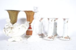 A Copeland and Spode cherub candle stick along with porcelain candle stick pairs