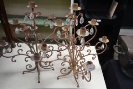 A pair of 20th century gilt scrolling candlabras each with hanging glass droplets