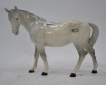 A Beswick horse in white stamped Beswick to foot