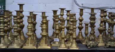 A large collection of Victorian candle sticks pairs along with other single candlesticks