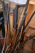 A large collection of early to mid 20th century cane golf clubs of various makes