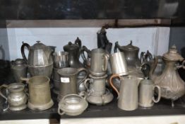 A large collection of Victorian and other pewter teapots and other pewter wares
