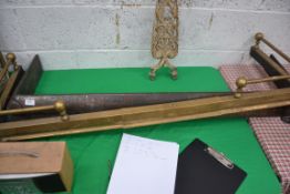 An adjustable brass fire fender along with an Arts and Crafts fire fender