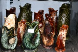 A good collection of Dartmouth gurgle fish jugs including Fosters etc.