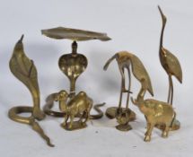 A collection of brass animals to include a snake coat peg and table , elephant , camel , stork etc.
