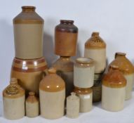 A large collection of earthenware salt glazed advertising drinks jars to include Doulton and many