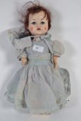 A vintage 1950s Pedigree toy doll in original vintage dress