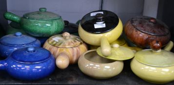 A good group of glazed pottery soup bowls with lids
