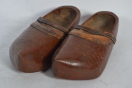 A pair of 19th Century carved wooden clogs of Dutch origin