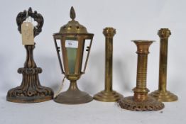 A Victorian cast iron doorstop along with a pair of art deco candlesticks on three tier bases ,
