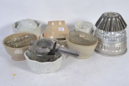 A large collection of Victorian jelly moulds to include copper and porcelain examples along with