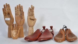 A group of 4 20th Century hand mannequins one being a smaller childs hand along with a group of