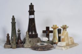 A group of graduating serpentine lighthouses along with a serpentine crucifix and various other