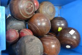 A good collection of vintage bowls mostly wooden along with a group of vintage cricket balls