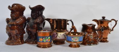A group of Victorian copper lustre jugs along with some Toby jugs