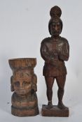 An early carved figure of a Centurion along with a carved African lady holding a basket