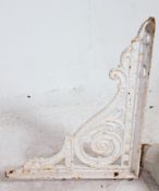 2 Victorian painted cast iron architectural wall brackets together with a salvaged rain hopper.