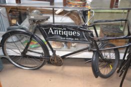 A vintage mid 20th century butchers bike with framework for a basket,