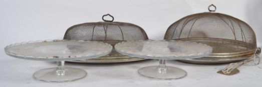 Two Wirex meat / cake cloches with sliver plate trays along with a pair of well decorated glass