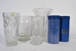A large cut glass vase along with other glass wares