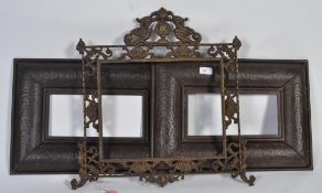 A rococo style picture frame with dragon and shell design along with a pair of metal picture frames