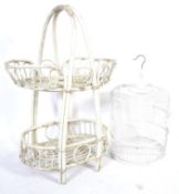 A 20th Century painted conservatory whicker whatnot etagere two tier basket along with a painted