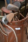 A collection of 20th Century golf clubs held within a vintage golfing bag