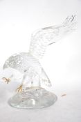 An unusual art glass sculpture of an eagle in flight with decorated features signed by artist