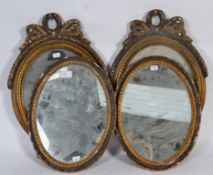 Two pairs of 20th Century carved wood framed mirrors of rococo design