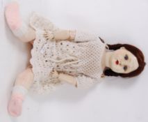 DOLL: An early to mid century composition jointed limbed doll, with composition head.
