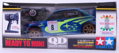 TAMIYA: A Tamiya ' Quick Drive ' 1:10 scale Subaru Impreza WRC. Within the original box.