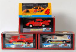 SCALEXTRIC: A collection of 4x Scalextric boxed slot racing cars,