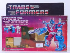 TRANSFORMERS: A vintage G1 Transformer ' Ultra Magnus ' action figure, within the original box.