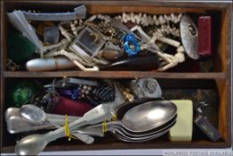 A vintage wooden trug containing various