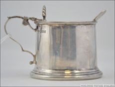 A silver hallmarked table mustard pot wi