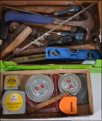 A box of vintage tools and measures .