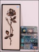 A metal and iridescent glass art sculptu