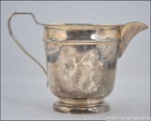 A silver hallmarked creamer jug bearing