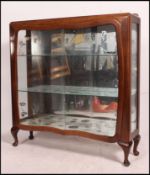 A 1950's walnut china display cabinet wi
