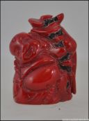A Chinese oriental carved coral buddha f