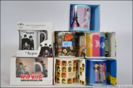 A collection of seven The Beatles mugs a