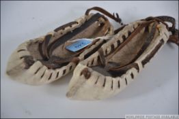 A pair of old rawhide ethnic inuit mocca