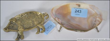 A mother of pearl and silver plated pin