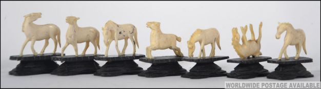 A collection of seven carvings of horses