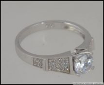 A silver 925 white metal and CZ dress ri