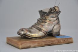 A silver plated pin cushion in the form