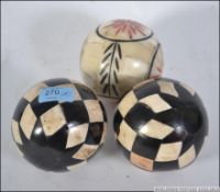 A collection of 3 bone - horn balls of s