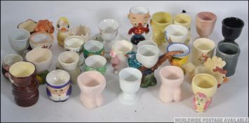 A collection of novelty egg cups to incl