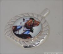 A silver perfume bottle with pictorial i