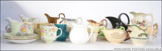 A collection of ceramic creamers to incl